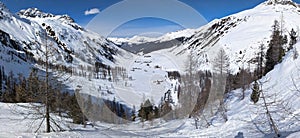 breathtaking mountain landscape near the alp Sertig. Snow mountains with Sun, Snow a river and beautiful trees, Swiss