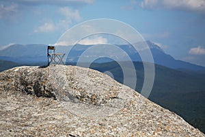 Breathtaking mountains view. Adventure travel. Summer vacations. Time to relax and dream. Chair on top of mountain