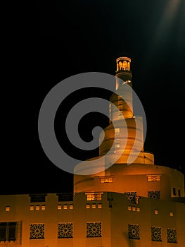 Fanar Mosque in Doha, Qatar â Illuminated Spiral Tower at Night photo