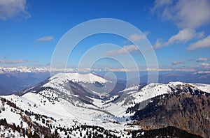 Breathtaking panorama of the Alps mountain range in winter with snow-capped peaks without people with blue sky