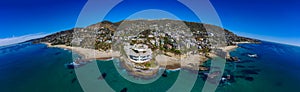 A breathtaking panoramic aerial shot of the vast blue ocean water along the coastline with sandy beaches