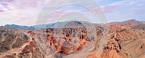 This breathtaking panoramic view captures the stunning red rock canyon nestled in the mountains