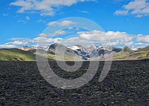 Breathtaking scene of Hvanngil valley and multi-colored rhyolite mountains on the background in sunny day with blue sky,