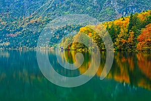 Breathtaking scenery of mountains, forests and lake with colorful reflections. Bohinj lake, Slovenia, Europe.