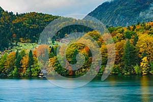 Breathtaking scenery of mountains, forests and lake with colorful reflections. Bohinj lake, Slovenia, Europe.