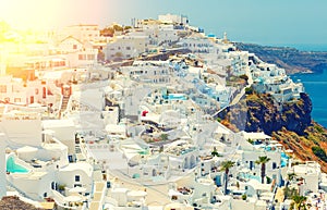 Breathtaking scenery of Oia village traditional Greek island architecture at Aegean sea and noon zenith sun flare