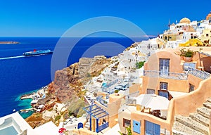 Breathtaking scenery of Oia village traditional Greek island architecture at Aegean sea and noon zenith sun flare