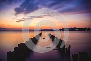 Breathtaking scenery of wooden poles at Lake Shinji in Matsue, Japan during sunset