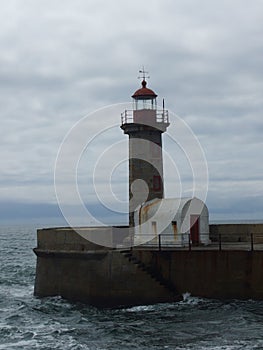 Breathtaking shot of the Felgueiras lighthouse on the ocean under cloudy sky in Porto, Portugal