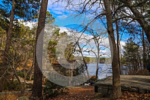 a breathtaking shot of the old wooden grist water mill at Stone Mountain Park with vast blue lake water