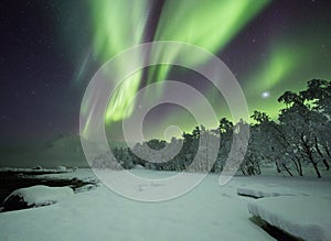 Breathtaking shot of wind of colors dancing over winter wonderland in Lofoten, Norway