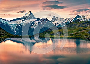 Breathtaking summer sunrise on Bachalpsee lake with Schreckhorn and Wetterhorn peaks on background.