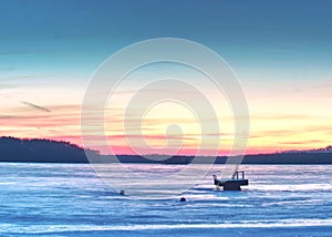 Breathtaking sunset with blue pink clouds over frozen lake