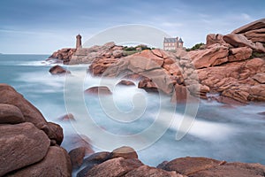 Breathtaking sunset with lighthouse and luxury villa, Ploumanach Mean Ruz in Perros-Guirec on Pink Granite Coast, Brittany, France