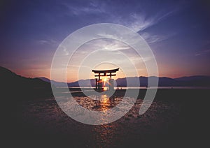 Breathtaking sunset over the famous historic floating torii of Miyajima, Japan