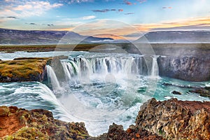 Breathtaking sunset scene of powerful Godafoss waterfall. Dramatic sky over Godafoss