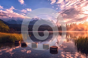 Breathtaking view of the alpine lake at sunrise, misty summer landscape, tourist resort lake Strbske Pleso, High Tatras, Slovakia