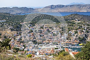 Breathtaking View of Colorful Houses and Port of Symi Below, the Blue Aegean Sea and the Mountains Beyond