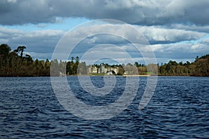 Breathtaking view of Lough Corrib, Ireland with Ashford Castle in the background, set against dark