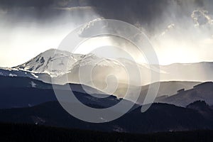 Breathtaking view of magnificent foggy Carpathian mountains, covered with ever-green forest on misty quiet morning or evening