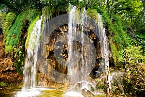 Breathtaking view of natural waterfall, lake cascade and water in deep tropical forest.