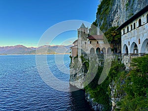 Breathtaking View of Santa Caterina del Sasso Hermitage Perched on the Cliffside Overlooking the Expansive Lake Maggiore photo