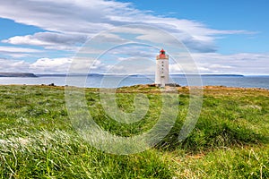 Breathtaking view of Skarsviti lighthouse in Vatnsnes peninsula on a clear day in North Iceland