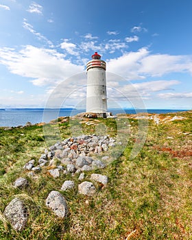 Breathtaking view of Skarsviti lighthouse in Vatnsnes peninsula on a clear day in North Iceland photo