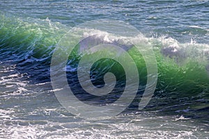 Breathtaking view of splashing sea waves under the sunlight in Varazze, Italy