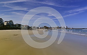 sunny sandy woljeong beach jeju island South Korea backed by blue sky with reflection on ocean photo