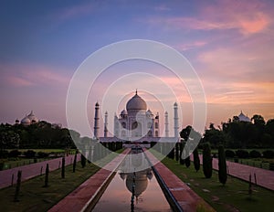 Breathtaking view of Taj Mahal mausoleum in Agra, India against colorful sunset sky