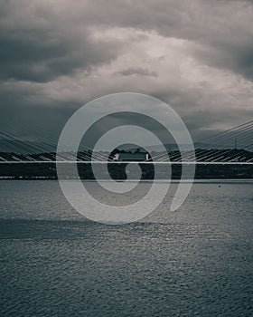 Breathtaking view of truck on Portimao bridge on dark cloudy sky background in Portugal