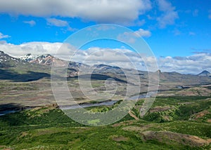 Breathtaking view valley of Thorsmork, with volcanoes, glaciers, green forest and blue sunny sky in summer day from the top of