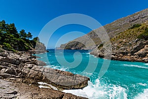 Breathtaking view of the waves and blue sea in Baia di Ieranto, Nerano, Naples