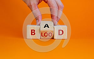 Breed bad blood symbol. Businessman turns cubes and changes the word 'bad' to 'blood'