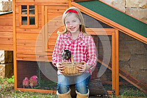 Breeder hens kid girl rancher farmer with chicks in chicken coop