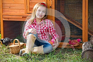 Breeder hens kid girl rancher farmer with chicks in chicken coop