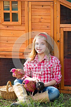 Breeder hens kid girl rancher farmer with chicks in chicken coop