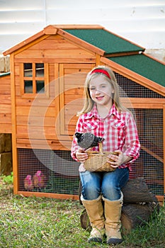 Breeder hens kid girl rancher farmer with chicks in chicken coop photo