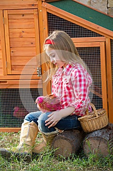 Breeder hens kid girl rancher farmer with chicks in chicken coop