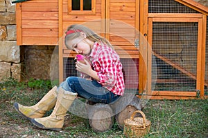 Breeder hens kid girl rancher farmer with chicks in chicken coop