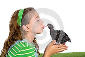 Breeder hens kid girl rancher farmer kissing a chicken chick photo