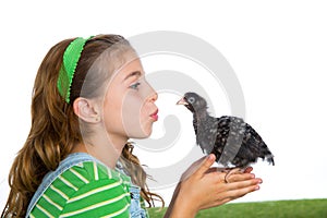 Breeder hens kid girl rancher farmer kissing a chicken chick photo