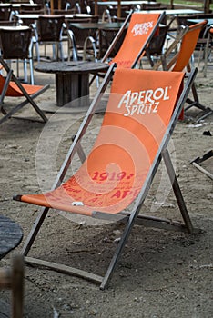 aperol Spritz logo on orange long chair at the restaurant terrace