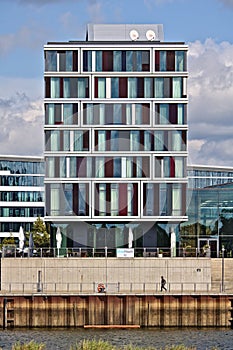 Bremen, Germany - September 14th, 2017 - Modern hotel building with waterfront sidewalk