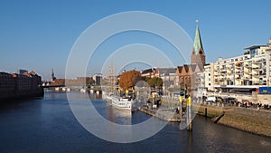 Bremen, Germany - View of the river Weser and the historic Schlachte waterfront with the spire of St. Martini church