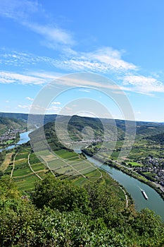 Bremm, Germany - 08 20 2020: view from Calmont to the Mosel curve with a ship and all three villages