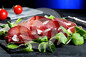 Bresaola on black stone photo