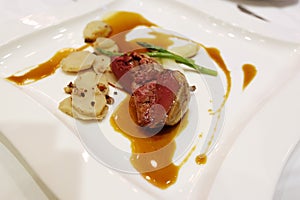 Bresse Pigeon with ginger stock and cinnamon potato photo