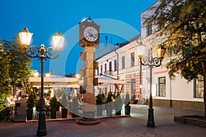 Brest, Belarus. Two-Sided Clock With Arms Of City Of Different Times In Form Of Six-Meter Bronze Monument On Pedestrian photo